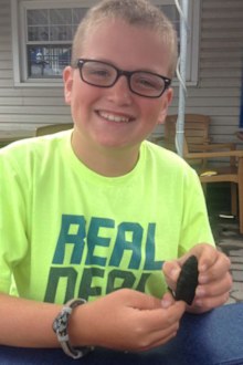 Noah Cordle with his 10,000-year-old discovery. (Supplied)