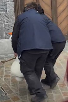 Disneyland Paris workers carry away an animatronic character of Olaf after it collapsed.