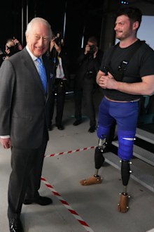 King Charles III speaks to David Henson a former soldier and Paralympian