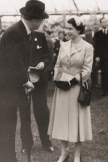 Queen Elizabeth speaks with officials during one of her first appearances at the Chelsea Flower Show.