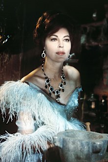 Gardner in period costume with an ornate necklace in a publicity portrait issued for the film, '55 Days at Peking', 1963. 