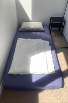 The two floor mattresses are separated by a partition. 