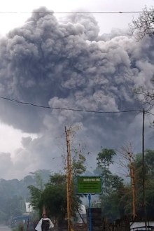 In this photo released by Indonesia's National Disaster Mitigation Agency (BNPB) Mount Semeru spews volcanic material during an eruption in Lumajang, East Java, Indonesia, Saturday, Jan. 16, 2021.