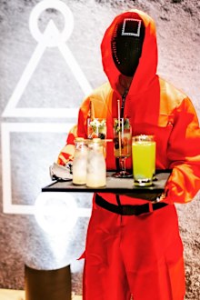 Chrissy Teigen hosts Squid Game-themed party.