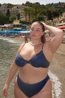 Riley Hemson poses on a beach in Europe.