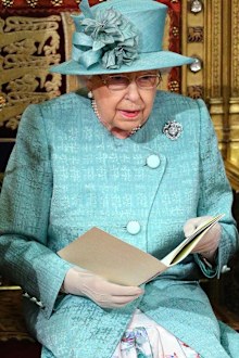 The Queen at the State Opening of Parliament, wearing a Stewart Parvin muted jade coat and printed silk dress.
