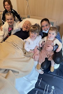 Bert Newton surrounded by his grandkids