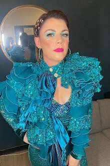 Em Rusciano poses in a blue ensemble.