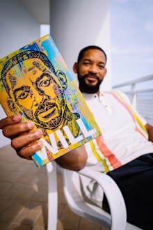 Will Smith holding his  new memoir Will