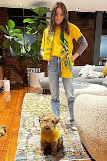 Rebecca Harding and Andy Lee watch the game at home with their dog dressed up for the occasion