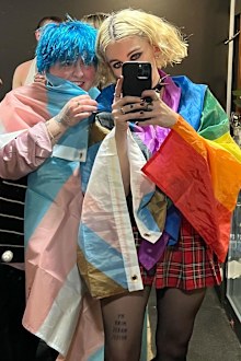 Baron-Gracie and Doran pose in the trans and gay pride flags. Doran identifies as non-binary.