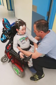 William in his power wheelchair, with is dad Ben.