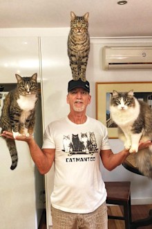 Robert Dollowet with his three cats.