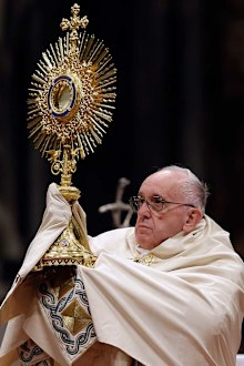 Pope Francis holds a monstrance as he celebrates a New Year's Eve vespers Mass in St. Peter's Basilica at the Vatican. (AAP)