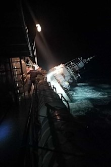 the HTMS Sukhothai corvette leans on its side off the coast of Prachuap Khiri Khan province.