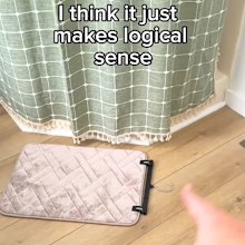 Lauren's bath mat drying hack using a coat hanger