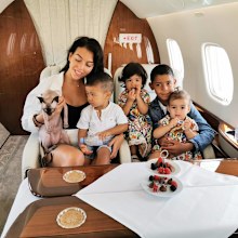 Cristiano Ronald's family poses with their Sphynx cat on a private jet.