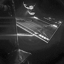 The dark comet lurks in the background, firing off a stream of gas and dust just 16km from the Rosetta mothership, and 480 million kilometres from Earth. (AAP)