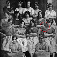 The hand doesn't seem to belong to any of the girls pictured.