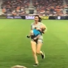 Mum runs off the grounds with her toddler firmly in hand.