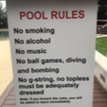 A sign displayed in the pool area at the building.