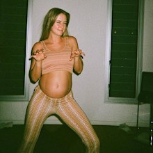 Steph Claire Smith poses in a two-piece set while pregnant.