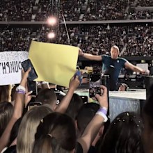 Chris Martin falls through a hole on the stage during Coldplay concert