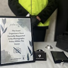 Hustlers Security's sign instructing wedding guests to not use their phones.