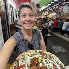 Rachel Davey posing with a mexican food dish