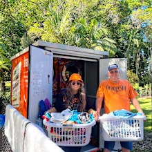 Two OrangeSky volunteers doing washing.