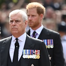 Prince Andrew, Duke of York and Prince Harry, Duke of Sussex walk behind the coffin during the procession for the Lying-in State of Queen Elizabeth II on September 14, 2022 in London, England.  