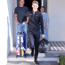 Oscar Piastri leaves his Melbourne home on his way back to Europe, watched by parents Chris and Nicole.