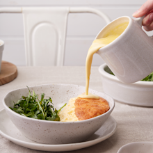 Goat's cheese souffle with creamy lemon cheese sauce