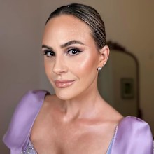 Keltie Knight wears a purple dress and full glam