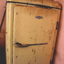 An old fashioned fridge found in the kitchen.