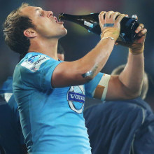 Stephen Hoiles of the Waratahs drinks champagne after winning the 2014 Super Rugby title.
