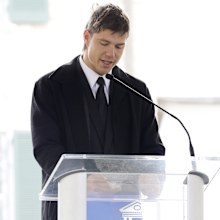 Ben Smith-Petersen reads a tribute by Riley Keough, Lisa Marie Presley's daughter, at the public memorial for Lisa Marie Presley
