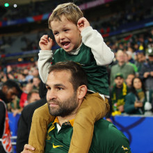 Cobus Reinach of South Africa celebrates victory with a child.