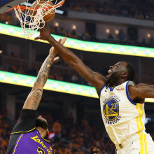 Draymond Green competes with Anthony Davis in the NBA playoffs.