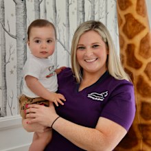 Anna Baker cuddles up to a cute baby.