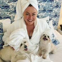Shelly Horton in bed with her dogs
