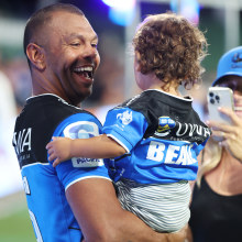 Kurtley Beale of the Force celebrates with his child after winning.