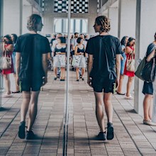 Man looking in mirror, walking