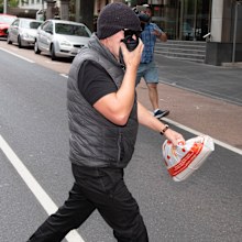 Workplace bullying claimant David Hingst covers his face as he leaves the Court of Appeal in Melbourne today.