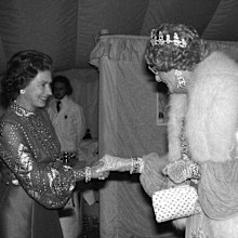 Queen Elizabeth II meets Dame Edna Everage - the creation of Australian humourist Barry Humphries at Windsor, when he was among the host stars appearing in the gala variety performance in the Big top at home Park in aid of the Queen's Silver Jubilee Appeal.   (Photo by PA Images via Getty Images)