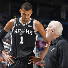 OKLAHOMA CITY, OK - OCTOBER 9: Victor Wembanyama #1 talks to Head Coach Gregg Popovich of the San Antonio Spurs during the game against the Oklahoma City Thunder on October 9, 2023 at the Paycom Center in Oklahoma City, OK. 