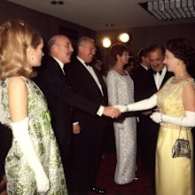 Queen Elizabeth shaking hands with Lionel Jeffries, watched by Sally Ann Howes (both stars of the film), at the Royal world premiere of the film 'Chitty Chitty Bang Bang' 