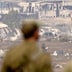 Israeli soldiers look across to northern Gaza from a viewpoint on the Israeli side of the border.