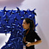 In this Monday, Nov. 5, 2018, file photo, a woman walks past the logo for Google at the China International Import Expo in Shanghai.