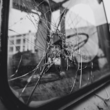 Stock image of a smashed car window.